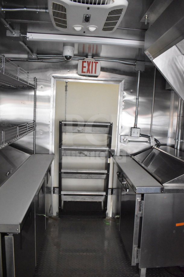 2021 Cruising Kitchens 8.5'x24' food trailer interior with CaptiveAire grease hood, refrigeration, griddle. Excellent condition.