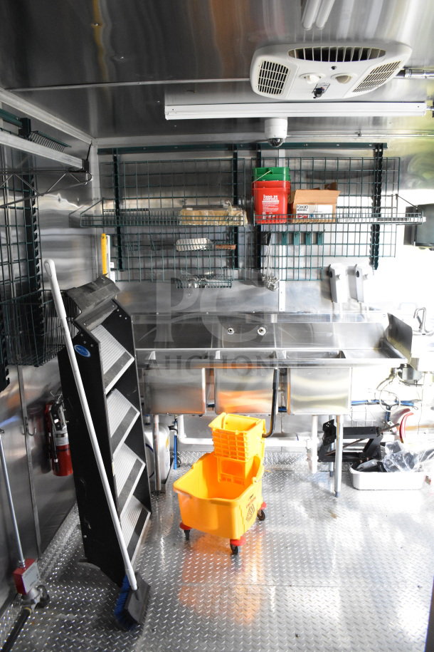 2021 Cruising Kitchens 8.5'x24' food trailer, interior view, stainless steel sink, shelving, CaptiveAire hood system.