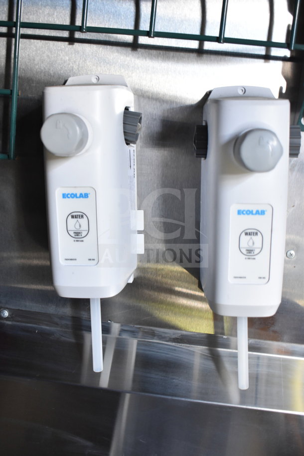 Ecolab water mixing dispensers inside a 2021 Cruising Kitchens food trailer, showcasing sanitation equipment.