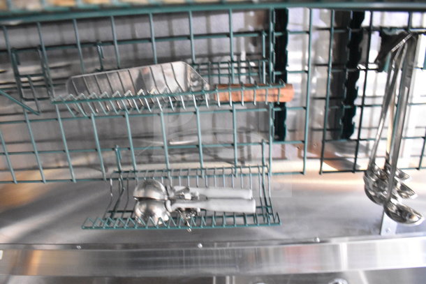 Interior of 2021 Cruising Kitchens food trailer with wire shelving, stainless steel utensils, and equipment visible.