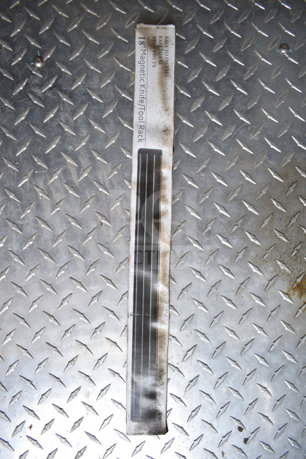 18" Magnetic Knife Tool Rack on diamond plate surface, worn and slightly soiled, labeled as easy to install.
