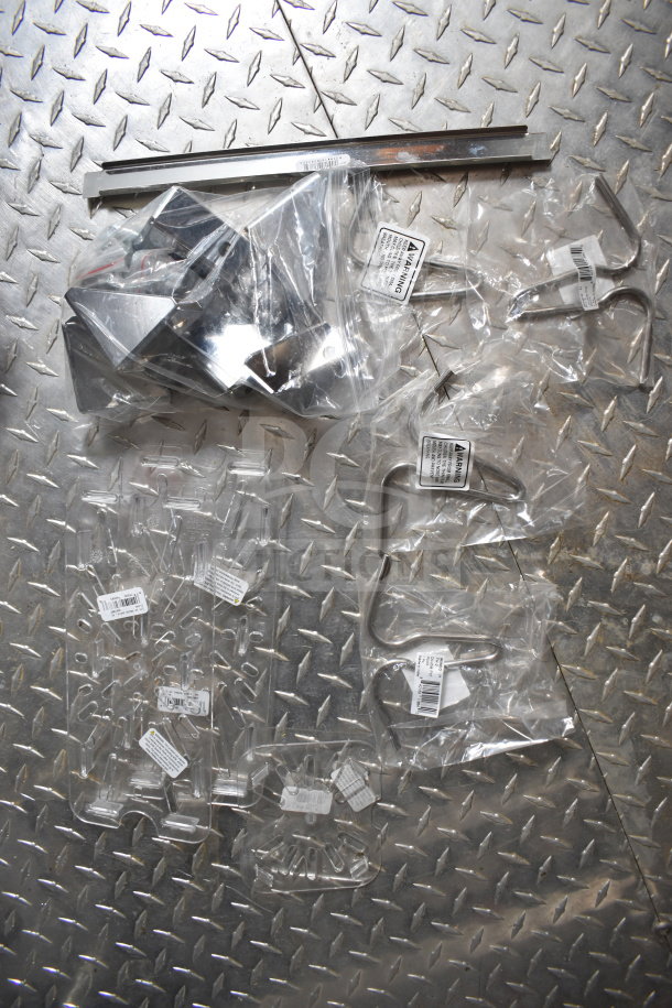 Packaging for metal hooks and brackets on diamond plate surface, labels show part numbers.