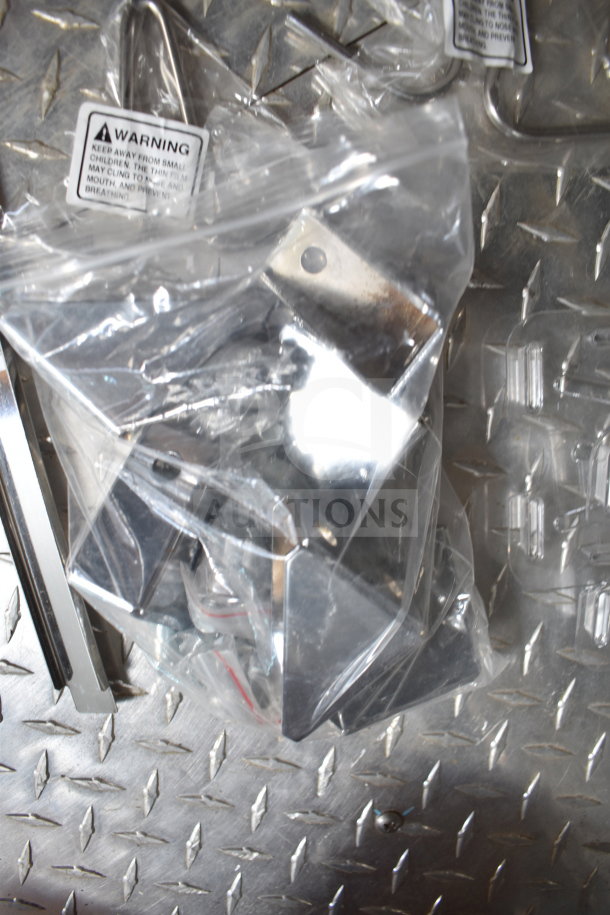 Plastic bag with metal brackets on diamond plate surface, warning label visible.