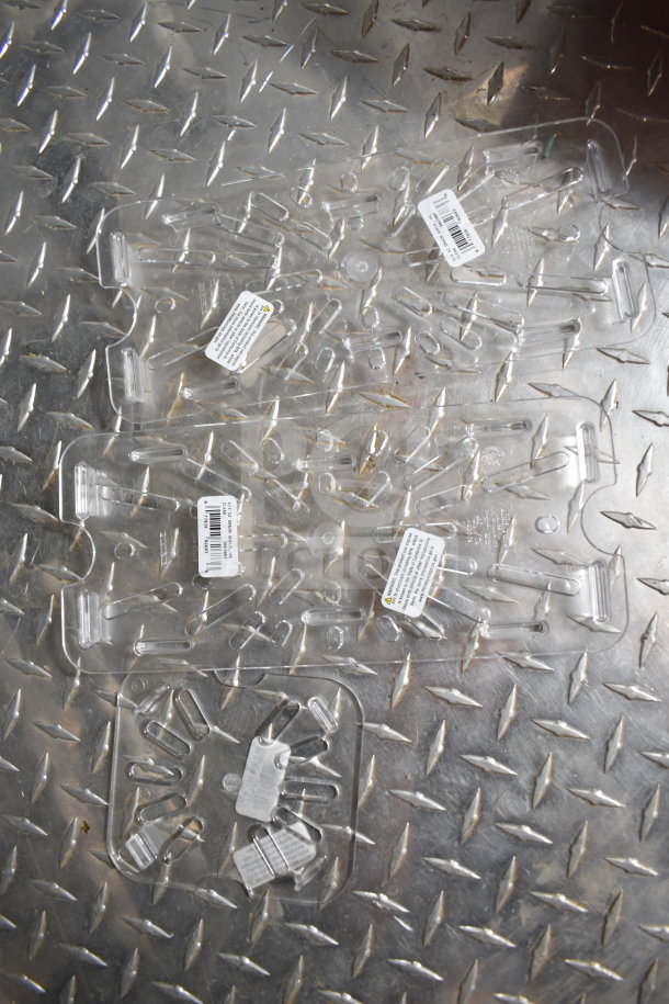 Clear plastic sheets with labels on a textured metal surface. Labels include barcodes and safety information.