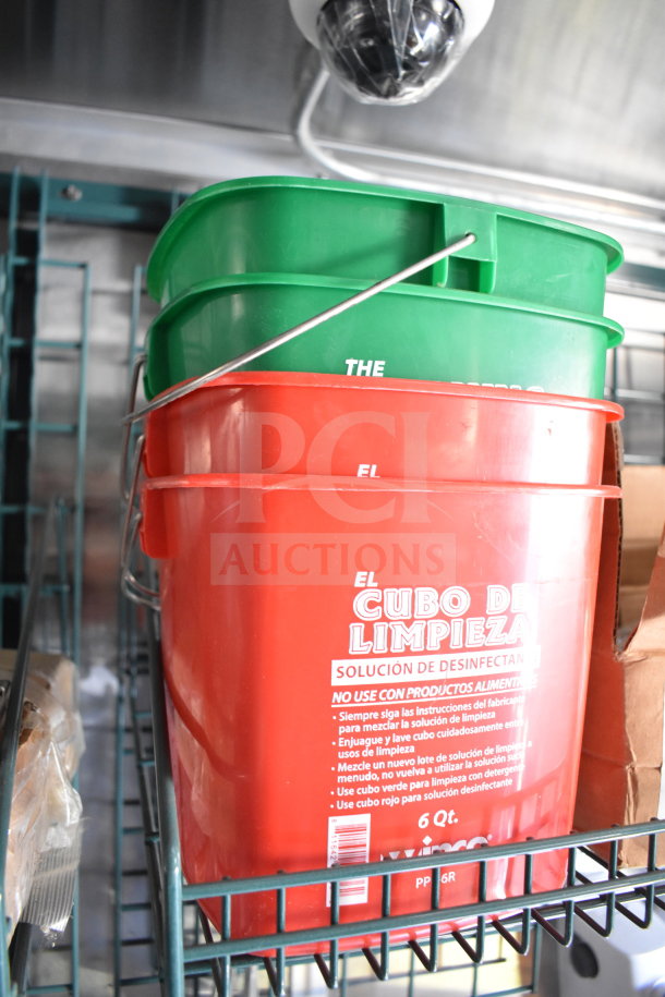 Interior view of a 2021 Cruising Kitchens food trailer, featuring cleaning buckets on a metal shelf.
