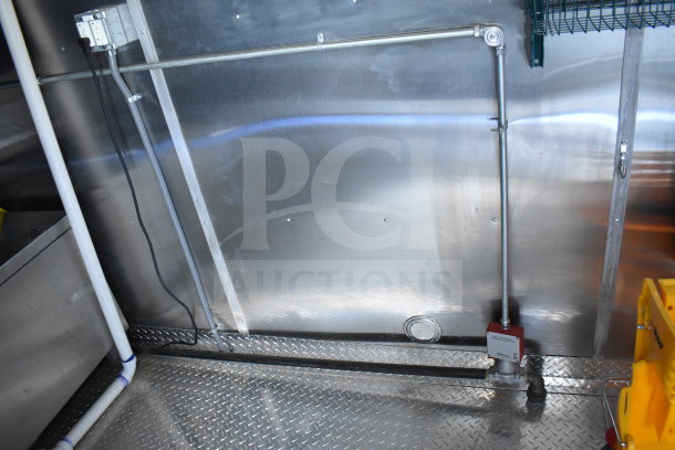 2021 Cruising Kitchens 8.5'x24' food trailer interior, featuring metal walls and diamond plate flooring.