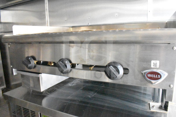 2021 Cruising Kitchens food trailer with Wells griddle, featuring knobs. Stainless steel finish. Includes CaptiveAire hood.