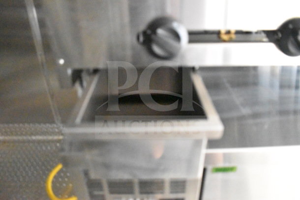 2021 Cruising Kitchens food trailer interior, featuring stainless steel construct, CaptiveAire grease hood, and stove controls.