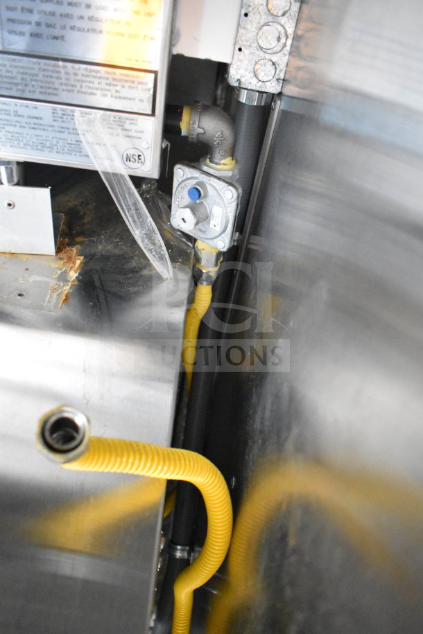2021 Cruising Kitchens food trailer interior, featuring CaptiveAire grease hood, suppression system, and yellow gas lines.