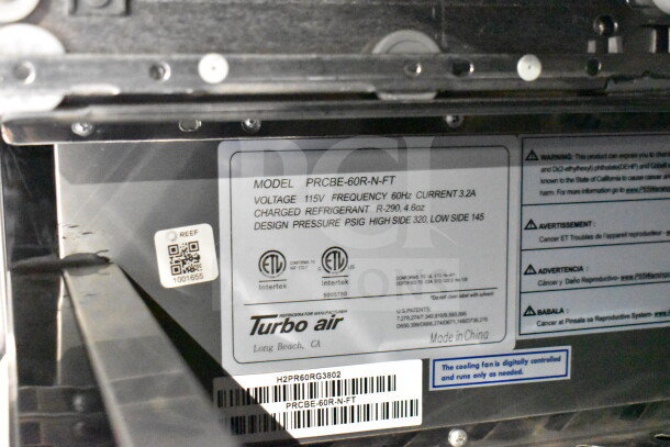 Label inside a food trailer showing model PRCBE-60R-N-FT by Turbo Air. Indicates voltage, frequency, and refrigerant details.