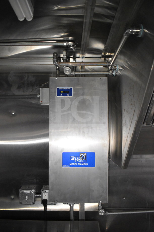 2021 Cruising Kitchens food trailer interior, featuring Pyro-Chem Model EN-MCU3 system. Stainless steel with visible pipes.