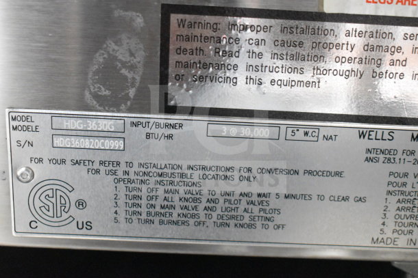 Label on Wells HDG-3630G griddle; shows model details, safety instructions, and serial number HDG360820C0999.