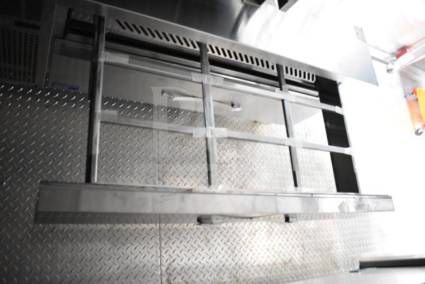 2021 Cruising Kitchens 8.5'x24' food trailer interior with diamond plate flooring and stainless steel fixtures.