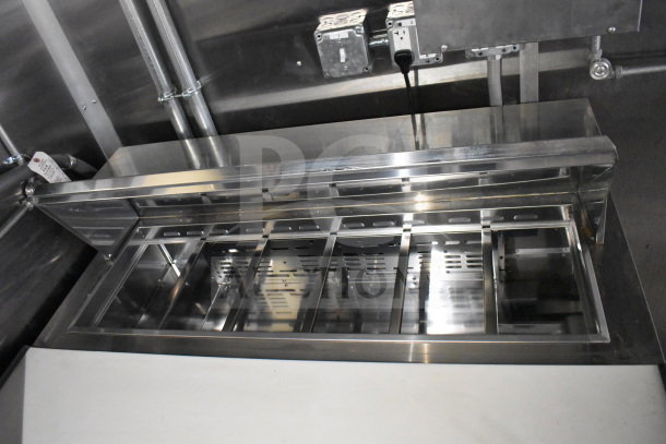 2021 Cruising Kitchens food trailer interior showing stainless steel refrigeration compartments.
