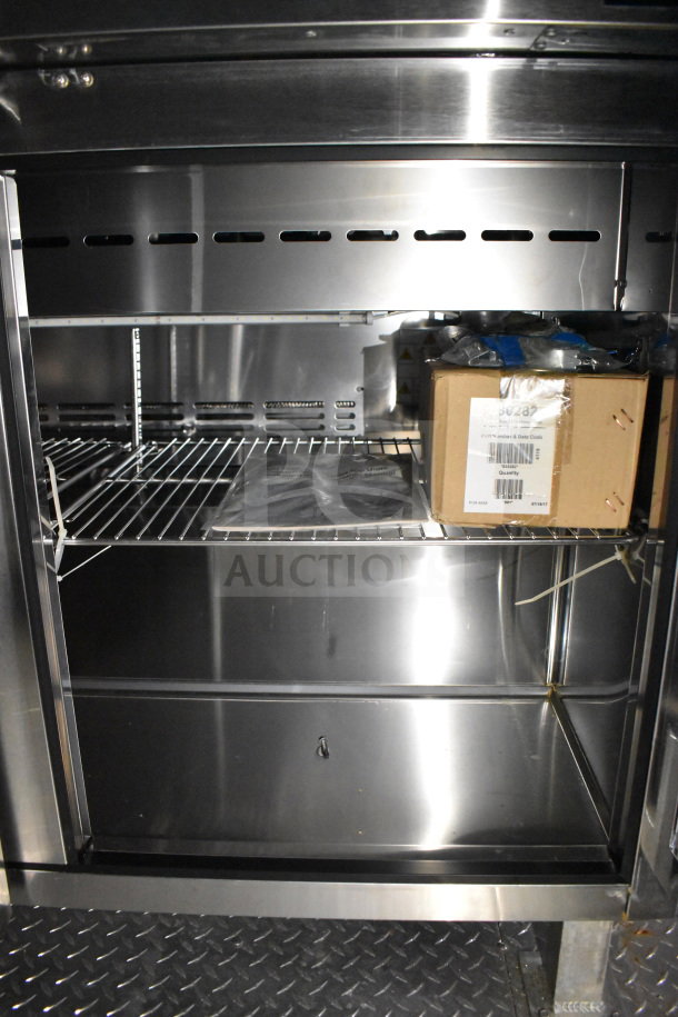 2021 Cruising Kitchens 8.5'x24' food trailer interior with CaptiveAire hood, shelves, and refrigeration. Clean, stainless steel.
