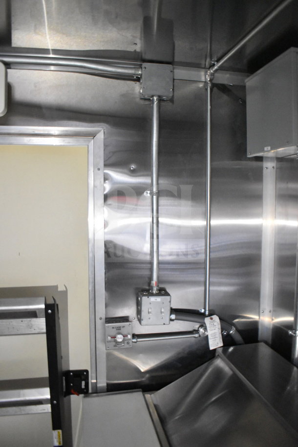 2021 Cruising Kitchens 8.5'x24' food trailer interior with CaptiveAire grease hood, stainless steel surfaces, and suppression system.