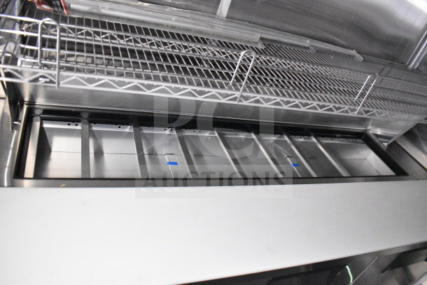2021 Cruising Kitchens 8.5'x24' food trailer interior, featuring CaptiveAire grease hood and suppression system, shelves.