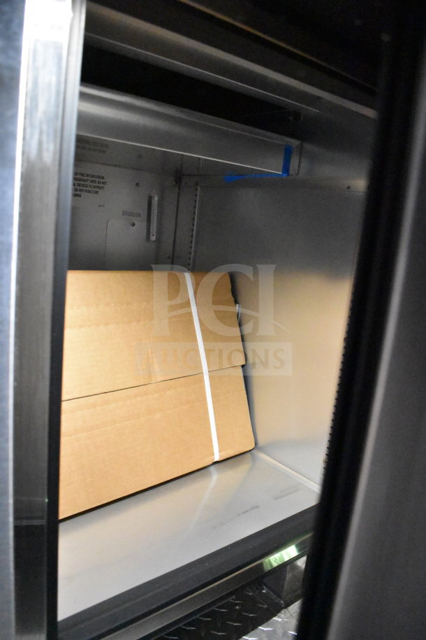 2021 Cruising Kitchens 8.5'x24' food trailer interior showing refrigeration unit with cardboard box, CaptiveAire system visible.