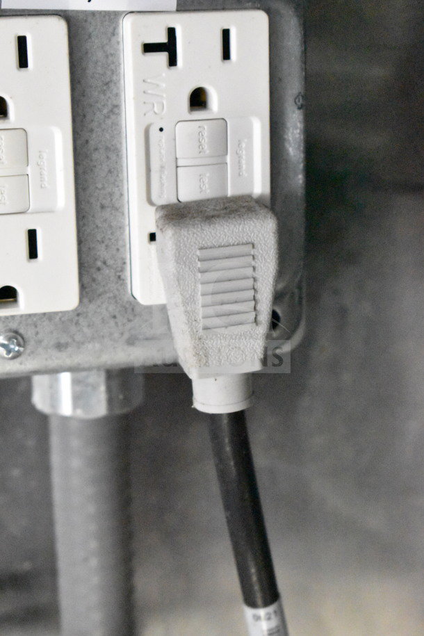 Power outlet inside 2021 Cruising Kitchens food trailer, featuring standard plug connection for electrical appliances.