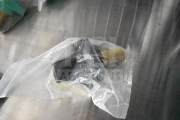 A small part wrapped in a plastic bag on a metallic surface, possibly a food trailer component.