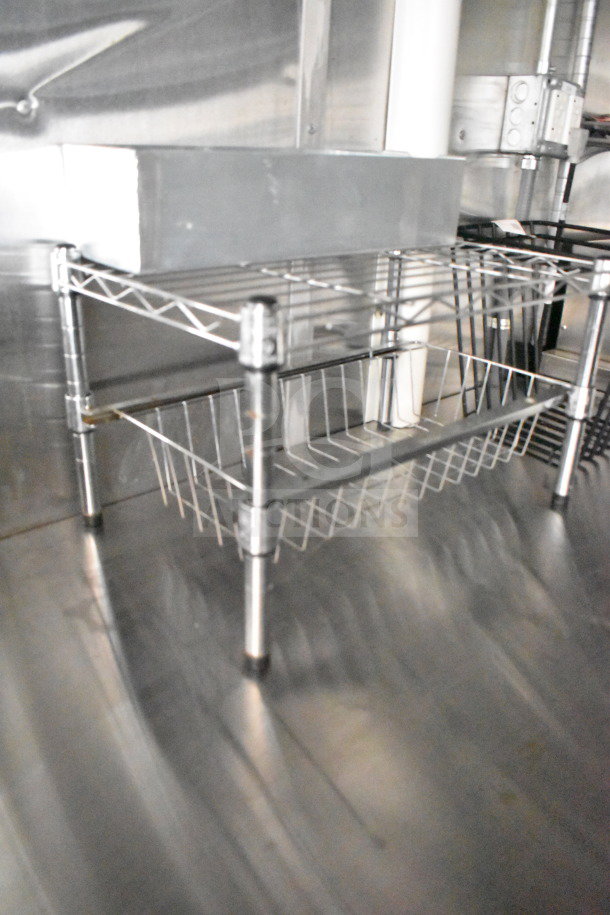 2021 Cruising Kitchens food trailer interior with metal shelving, CaptiveAire grease hood, and stainless steel finish.