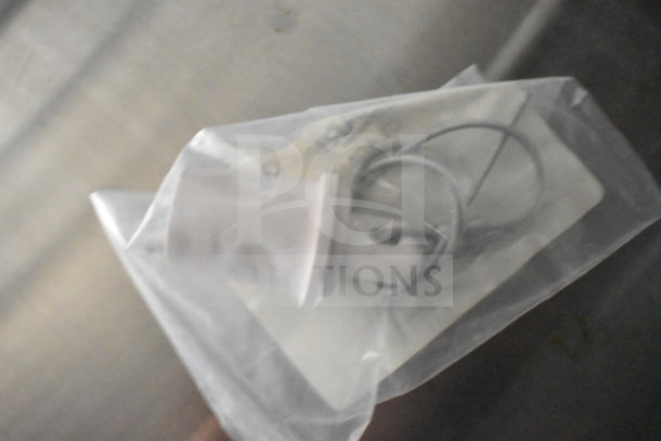A plastic-wrapped item with a cable loop and tag, possibly related to the 2021 Cruising Kitchens food trailer.