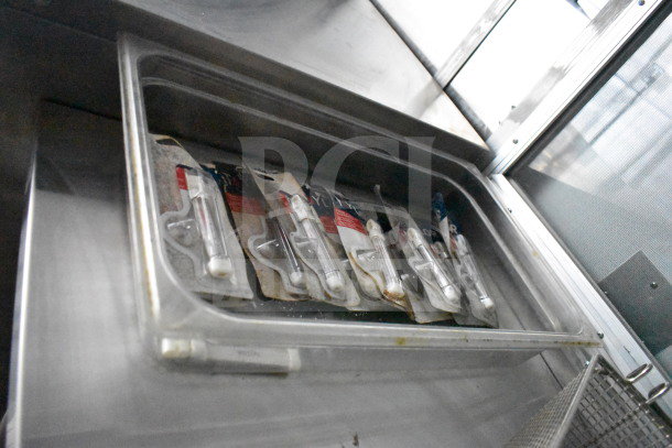 2021 Cruising Kitchens food trailer interior with open storage compartment showcasing multiple packaged items.