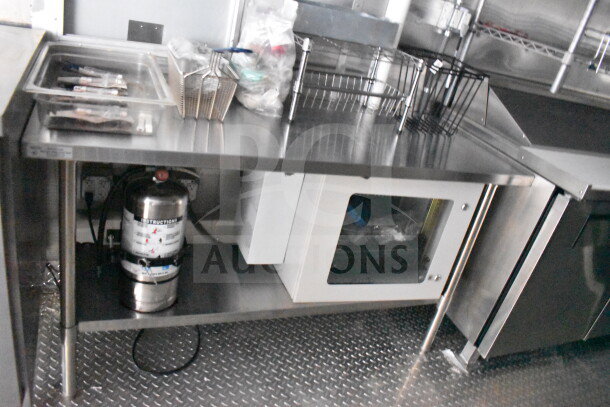 2021 Cruising Kitchens food trailer interior with CaptiveAire grease hood, suppression system, and stainless steel surfaces.