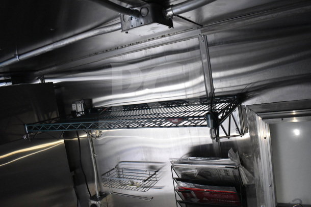 2021 Cruising Kitchens food trailer interior with metal shelving, electrical outlets, and storage racks, in excellent condition.