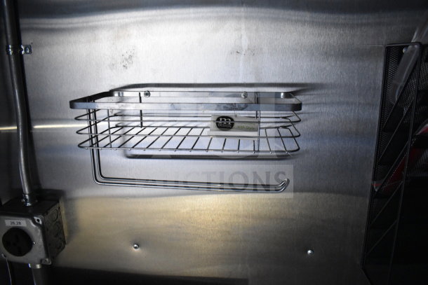Stainless steel shelf installed inside a 2021 Cruising Kitchens food trailer. Clean, robust design for easy organization.