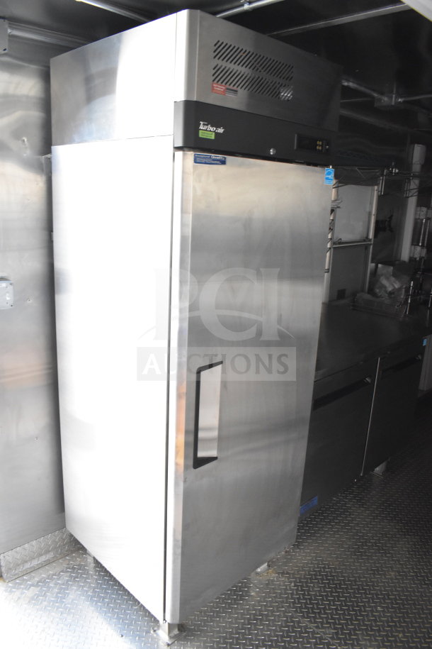2021 Cruising Kitchens food trailer interior showing Turbo Air commercial refrigerator, used condition, stainless steel finish.