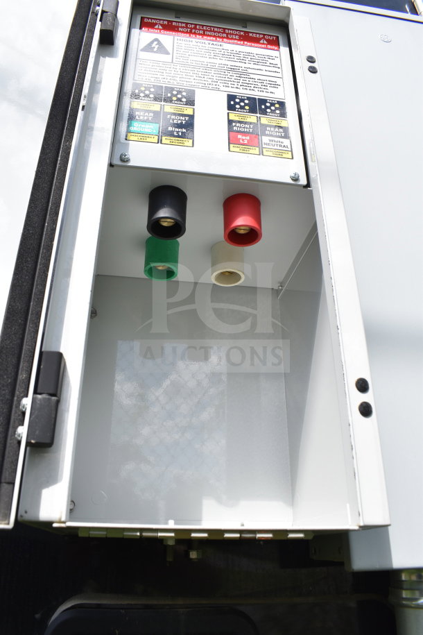 2021 Cruising Kitchens food trailer electrical panel, showing high voltage warning and color-coded cable connections.
