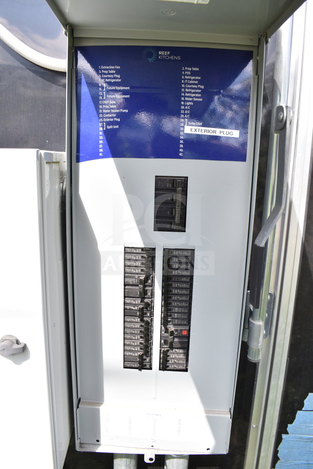 Electrical panel inside a 2021 Cruising Kitchens 8.5'x24' food trailer. Reef Kitchens label with circuit list visible.