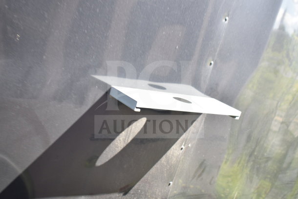2021 Cruising Kitchens food trailer wall with mounted metal bracket; surface shows minor wear.