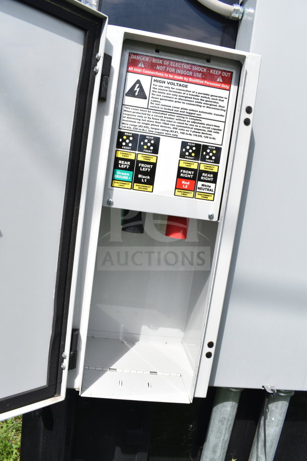 Electrical panel on a 2021 Cruising Kitchens food trailer, featuring high voltage warnings and connection labels.