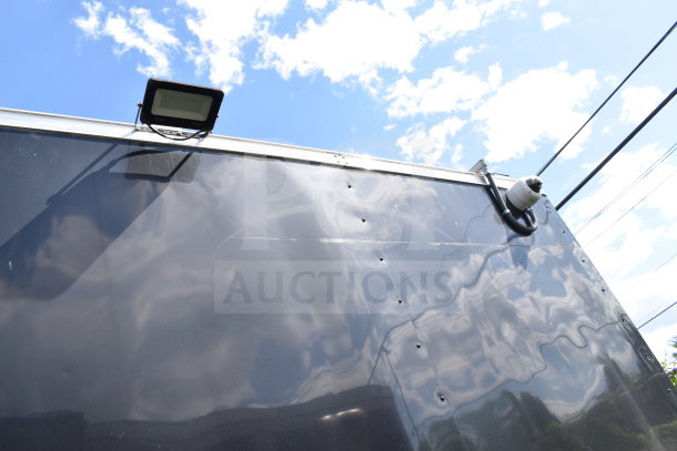 2021 Cruising Kitchens food trailer exterior with mounted security camera and light fixture.