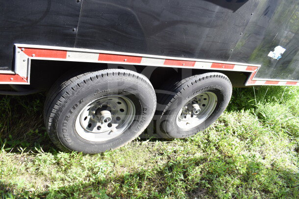 2021 Cruising Kitchens 8.5'x24' food trailer wheels, featuring dual Goodride tires and a sturdy metal exterior with red trim.