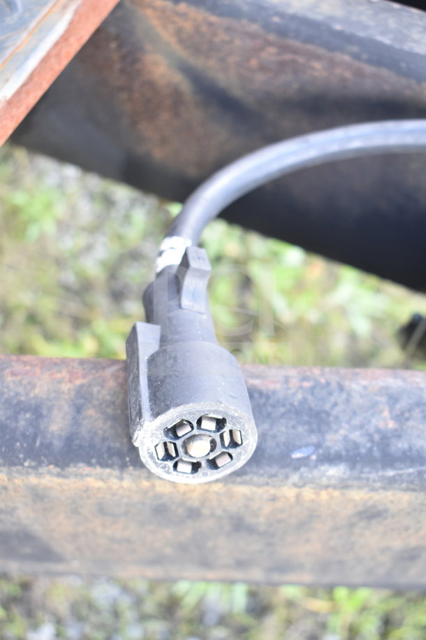 Close-up of a trailer hitch connector on a 2021 Cruising Kitchens food trailer, showing a circular socket in good condition.