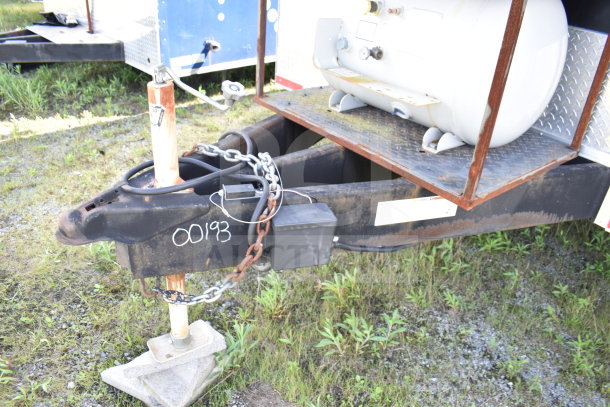2021 Cruising Kitchens food trailer hitch, VIN 00193, showing chain, cables, and a propane tank on diamond plate.