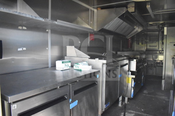 2020 Diamond Cargo 8.5'x24' food trailer interior with stainless steel appliances, storage shelves, and ventilation hood, VIN: 53NBE2422L1083693.