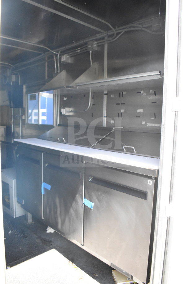 2020 Diamond Cargo 8.5'x24' food trailer interior, featuring stainless steel surfaces and storage, in excellent condition.