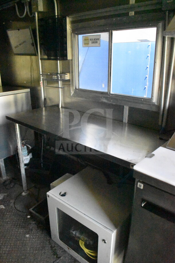 2020 Diamond Cargo 8.5'x24' food trailer interior, featuring stainless steel counter, window, and storage unit.