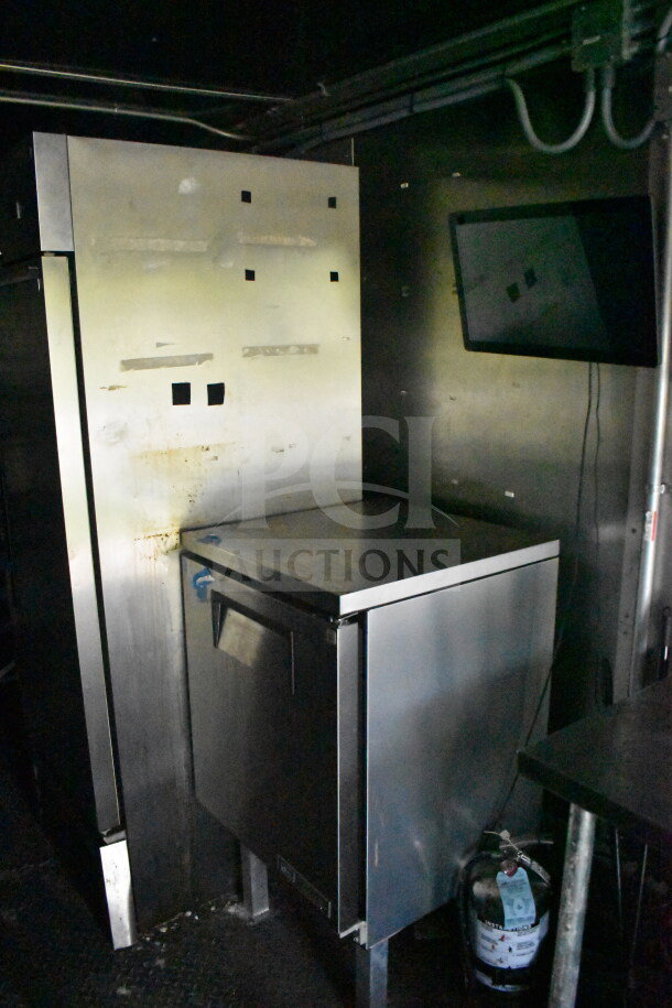 2020 Diamond Cargo 8.5'x24' food trailer interior, featuring stainless steel surfaces, storage cabinet, and fire extinguisher.