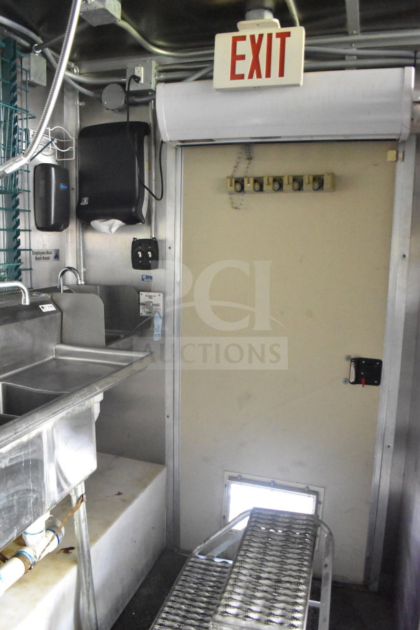 2020 Diamond Cargo 8.5'x24' Food Trailer interior with stainless steel sink, "Exit" sign, and washing station.