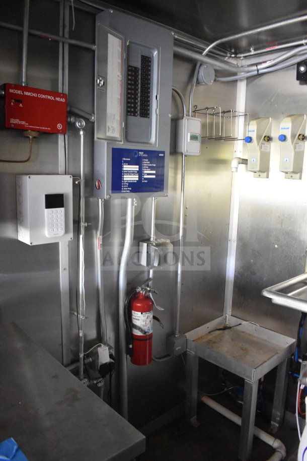 2020 Diamond Cargo 8.5'x24' food trailer interior showing electrical panel, control system, and fire extinguisher in stainless steel setup.
