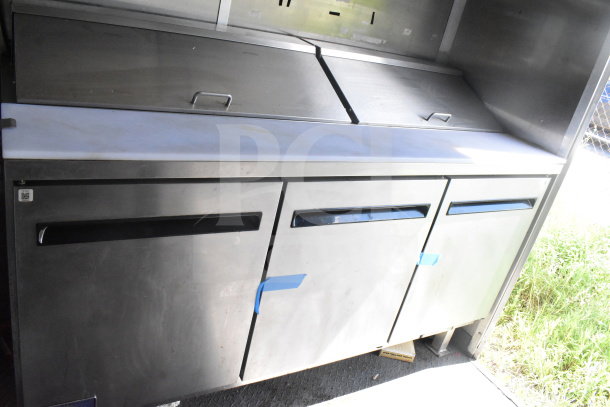 Stainless steel food preparation unit inside a 2020 Diamond Cargo 8.5'x24' food trailer, with three compartments and top lids.