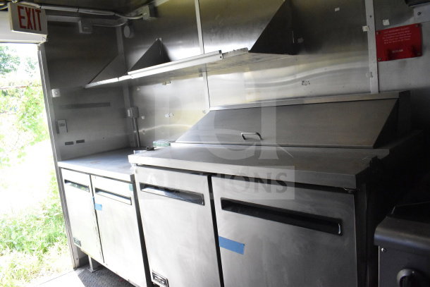 2020 Diamond Cargo 8.5'x24' Food Trailer interior with stainless steel counters and refrigeration units.