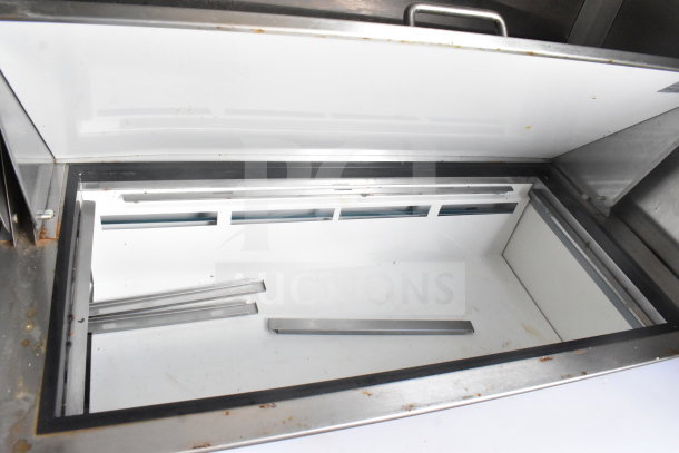 2020 Diamond Cargo 8.5'x24' food trailer interior, showing a large, open stainless steel and white storage compartment, in good condition.