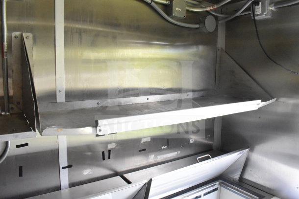2020 Diamond Cargo 8.5'x24' food trailer interior with stainless steel shelves and power connections. Good condition.