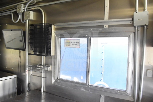 2020 Diamond Cargo 8.5'x24' Food Trailer interior. Includes serving window, shelving, and wiring in good condition.